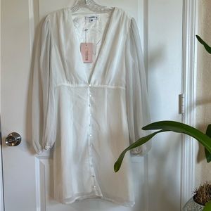 Deep plunging whimsical dress with peasant sleeve and pearlescent button detail